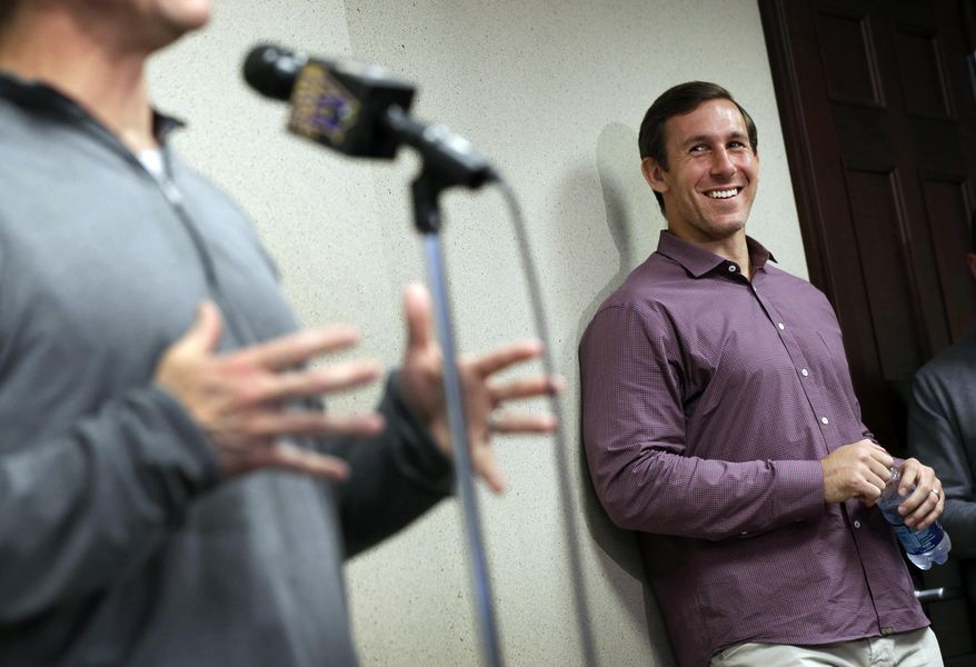 Baltimore Ravens tight end Owen Daniels laughs before being introduced by head coach John Harbaugh during an NFL football news conference, Friday, April 4, 2014, at the team's practice facility in Owings Mills, Md. Daniels, a former member of Houston Texans, joins his former head coach, Gary Kubiak, who is now Baltimore's offensive coordinator. (AP Photo/Patrick Semansky)