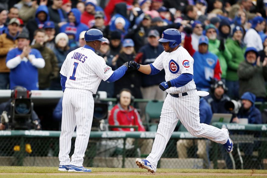 Chicago Cubs Welington Castillo, right, celebrates with third base coach Gary Jones after he hit a home run against the Philadelphia Phillies during the second inning of a baseball game on Friday, April 4, 2014, in Chicago. (AP Photo/Andrew A. Nelles)