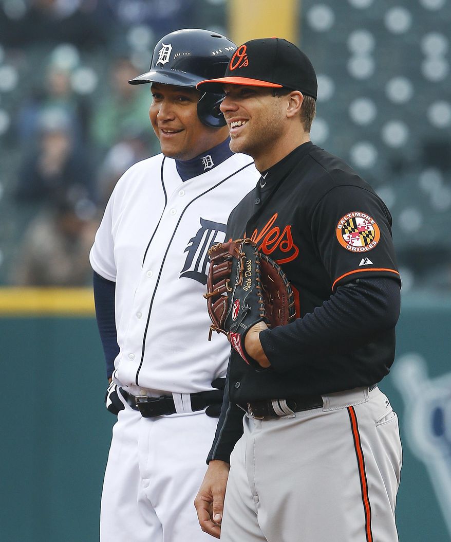 Detroit Tigers' Miguel Cabrera, left, talks with Baltimore Orioles first baseman Chris Davis while on first base in the first inning of a baseball game in Detroit, Friday, April 4, 2014. (AP Photo/Paul Sancya)