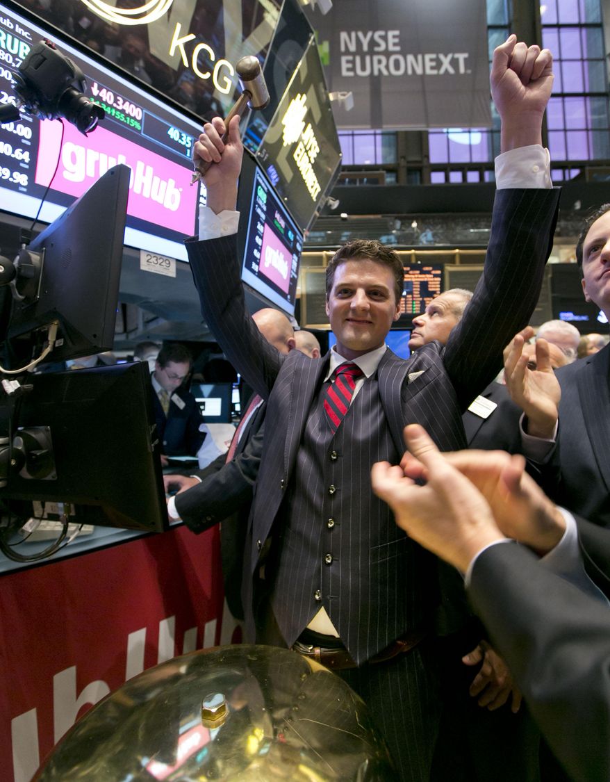 GrubHub CEO Matthew Maloney raises his arms in celebration after ringing a ceremonial bell as his company's IPO begins trading, on the floor of the New York Stock Exchange Friday, April 4, 2014. Investors sent shares of online food ordering service GrubHub Inc. up 51 percent to $39.20 in early trading in its stock market debut Friday. (AP Photo/Richard Drew)