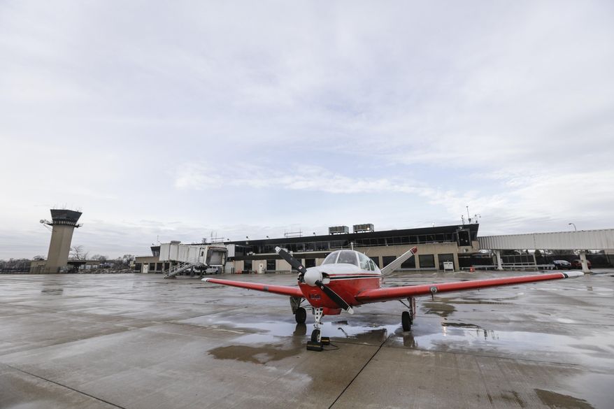 A plane sits on the runway at the Coleman A Young Municipal airport on Thursday, April 3, 2014 in Detroit. The aging airport get passenger service again if $28.5 million in funding is approved as part of the city's bankruptcy plan, officials said. The money for Coleman A. Young International Airport on the city's east side would pay to upgrade hangars and the airport's passenger terminal. It also would fund a new loading bridge for passengers. (AP Photo/Detroit Free Press, Jarrad Henderson) DETROIT NEWS OUT; NO SALES