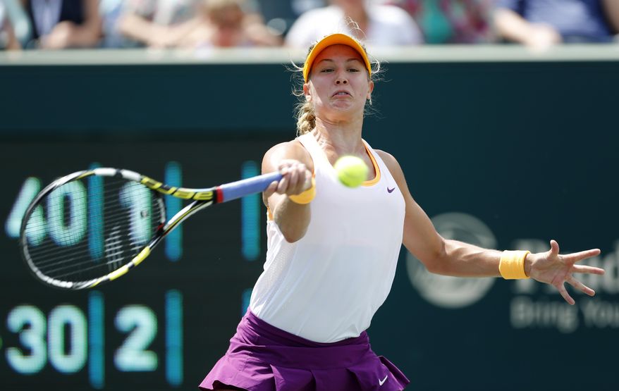 Eugenie Bouchard, of Canada, returns to Jelena Jankovic, of Serbia, during the Family Circle Cup tennis tournament in Charleston, S.C., Friday, April 4, 2014. (AP Photo/Mic Smith)