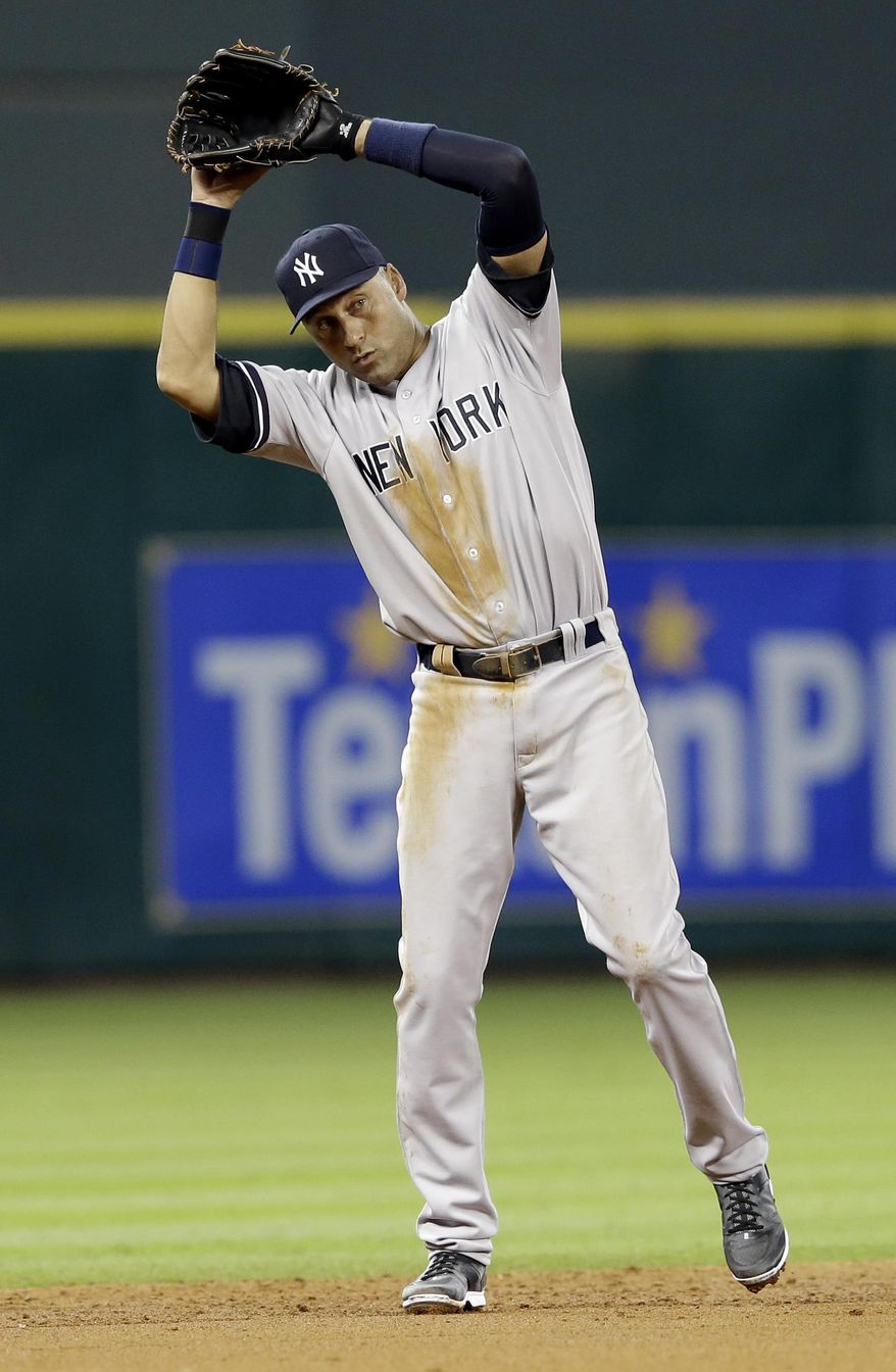 New York Yankees shortstop Derek Jeter reacts as he watches pitcher Ivan Nova walk Houston Astros' Jose Altuve in the fifth inning of a baseball game on Thursday, April 3, 2014, in Houston. (AP Photo/Pat Sullivan)