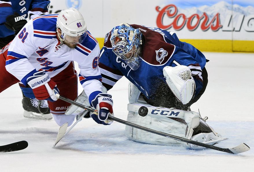 Colorado Avalanche goalie Semyon Varlamov (1), of Russia, blocks a shot by New York Rangers left wing Rick Nash (61) during the second period of an NHL hockey game on Thursday, April 3, 2014, in Denver. (AP Photo/Jack Dempsey)
