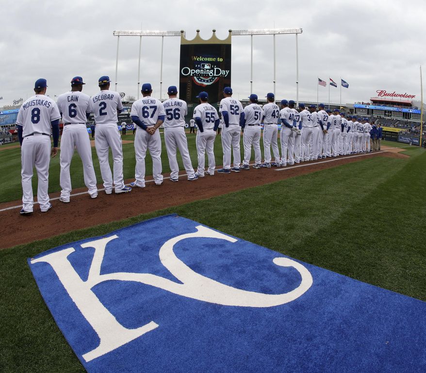 Players for the Kansas City Royals stand for the national anthem before a home opener baseball game against the Chicago White Sox Friday, April 4, 2014, in Kansas City, Mo. (AP Photo/Charlie Riedel)