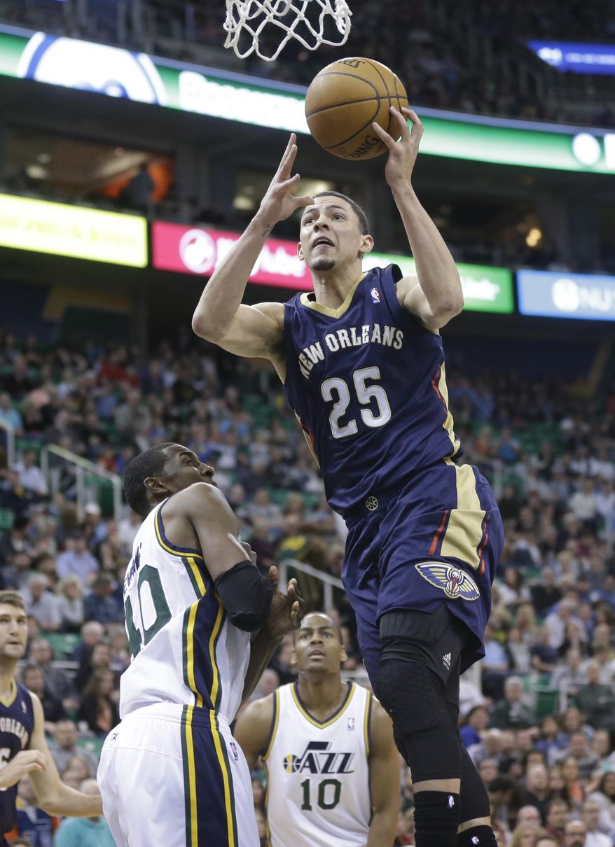 New Orleans Pelicans' Austin Rivers (25) goes to the basket as Utah Jazz's Jeremy Evans, left, and Alec Burks (10) defend in the second quarter during an NBA basketball game on Friday, April 4, 2014, in Salt Lake City. (AP Photo/Rick Bowmer)