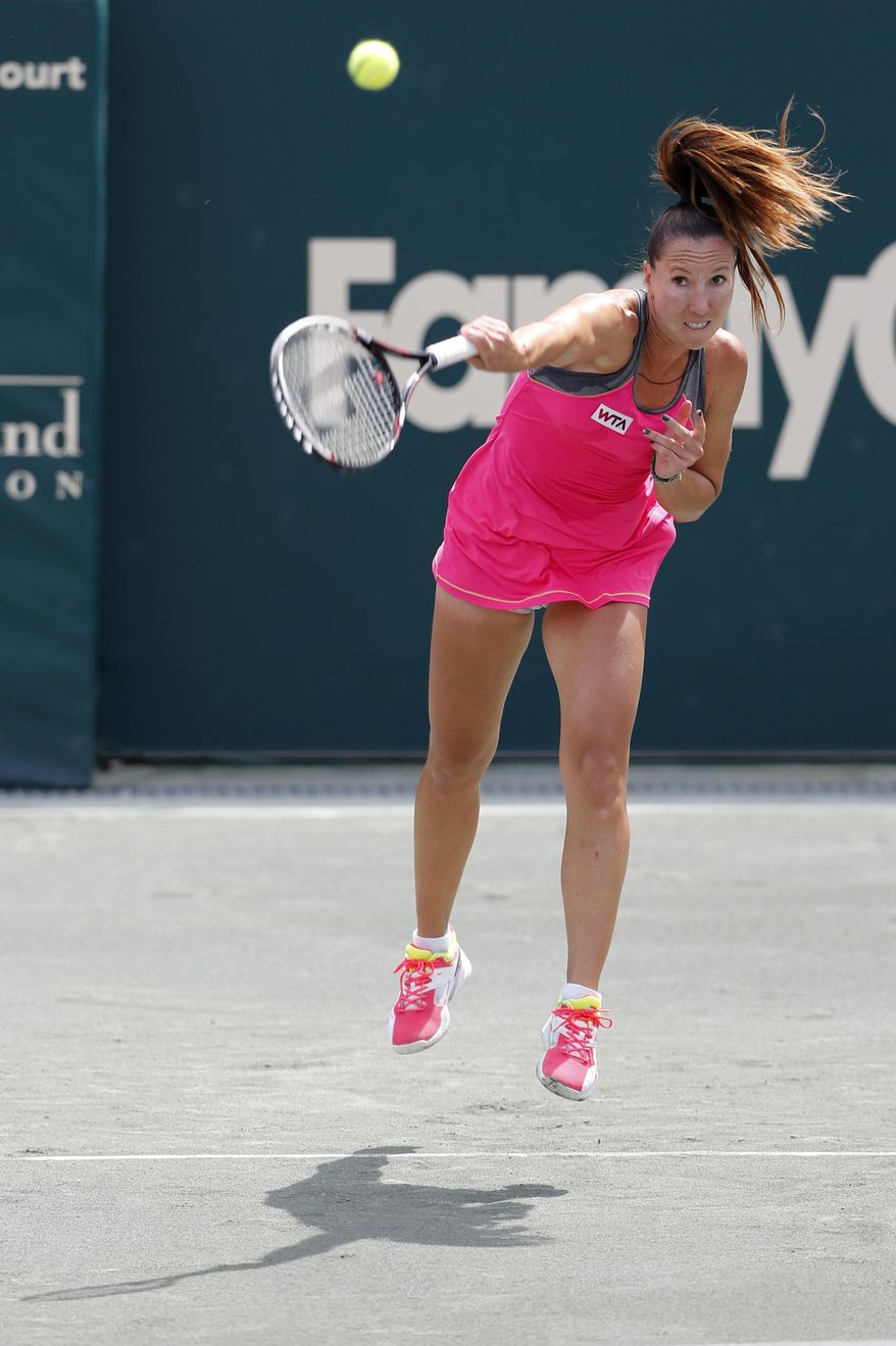Jelena Jankovic, of Serbia, serves to Eugenie Bouchard, of Canada, during the Family Circle Cup tennis tournament in Charleston, S.C., Friday, April 4, 2014. (AP Photo/Mic Smith)