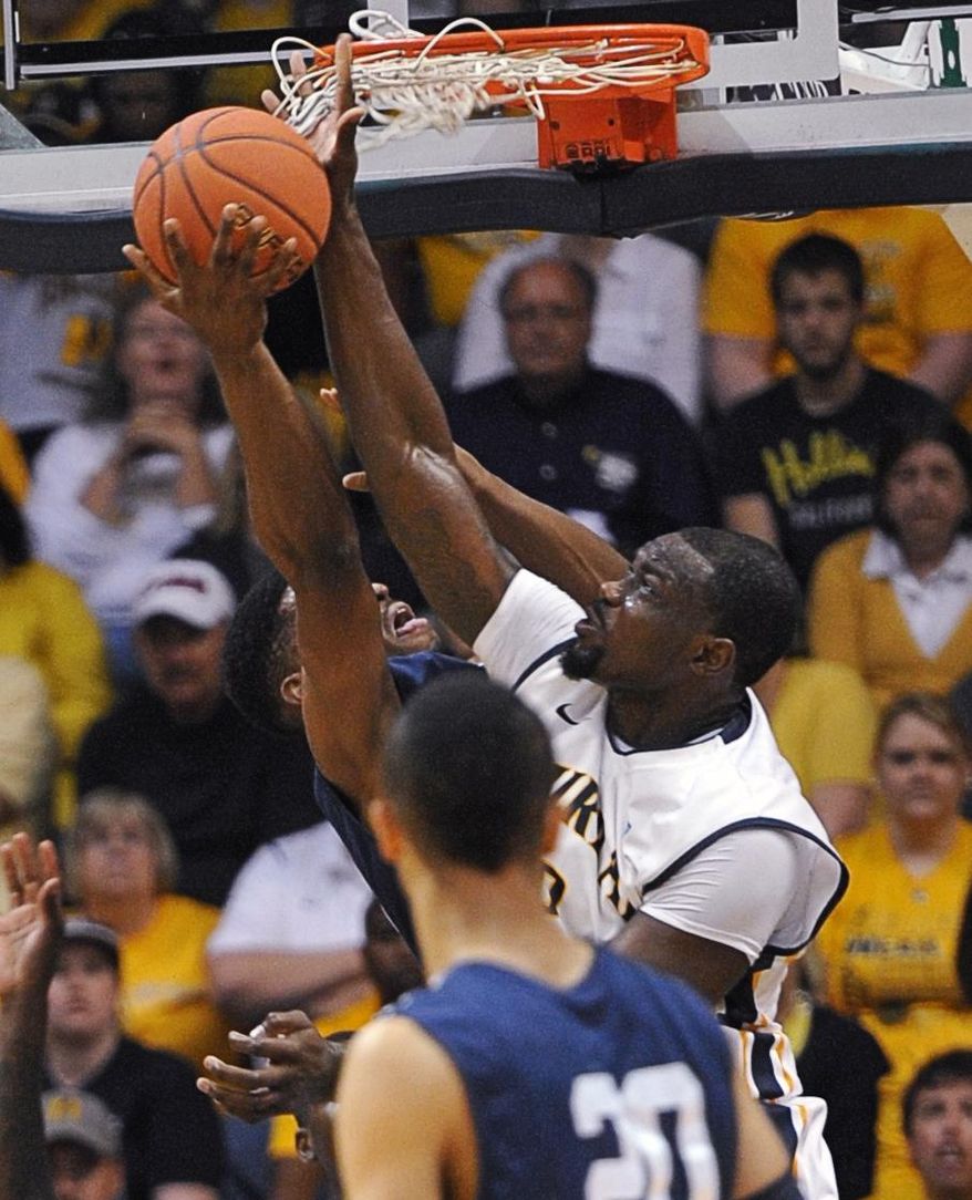 Murray State's Jonathan Fairell blocks a shot by a Yale player, left, in the first half of an NCAA college basketball game for the CollegeInsider.com tournament championship, Thursday, April 4, 2014, in Murray, Ky. (AP Photo/The Ledger, Kyser Lough)