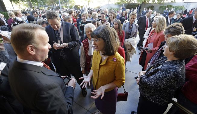 FILE - In this Oct. 5, 2013,file photo, Kate Kelly, center, with a group of about 200 feminist women are denied entrance to an all-male meeting of Mormon priesthood during the Mormon church conference, in Salt Lake City. More than 100,000 Latter-day Saints are expected in Salt Lake City this weekend for the church&#x27;s biannual general conference. A Mormon&#x27;s women group pushing the church to allow women in the priesthood plans to demonstrate outside an all-male meeting Saturday. The church has asked them to reconsider, and barred media from going on church property during the demonstration. (AP Photo/Rick Bowmer, File)