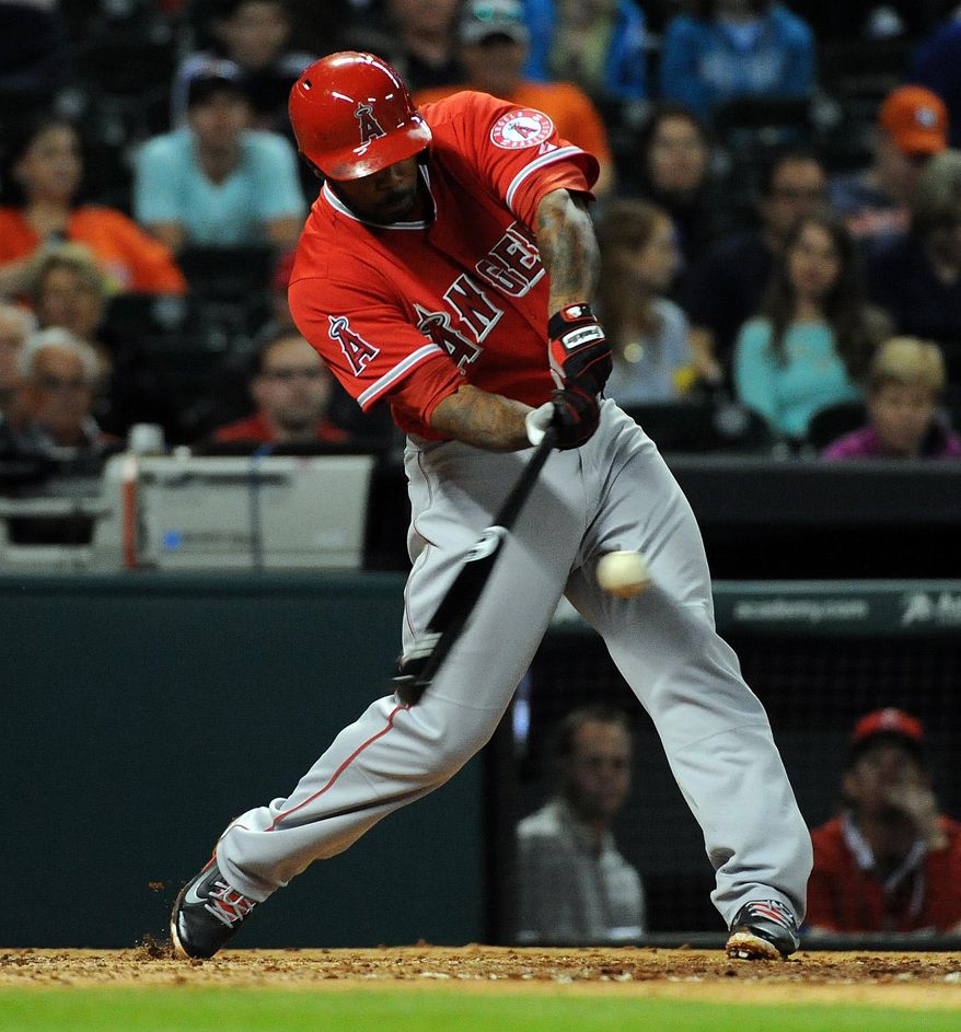 Los Angeles Angels' Howie Kendrick hits a one-run double in the third inning of a baseball game against the Houston Astros, Friday, April 4, 2014, at Minute Maid Park in Houston. (AP Photo/Eric Christian Smith)