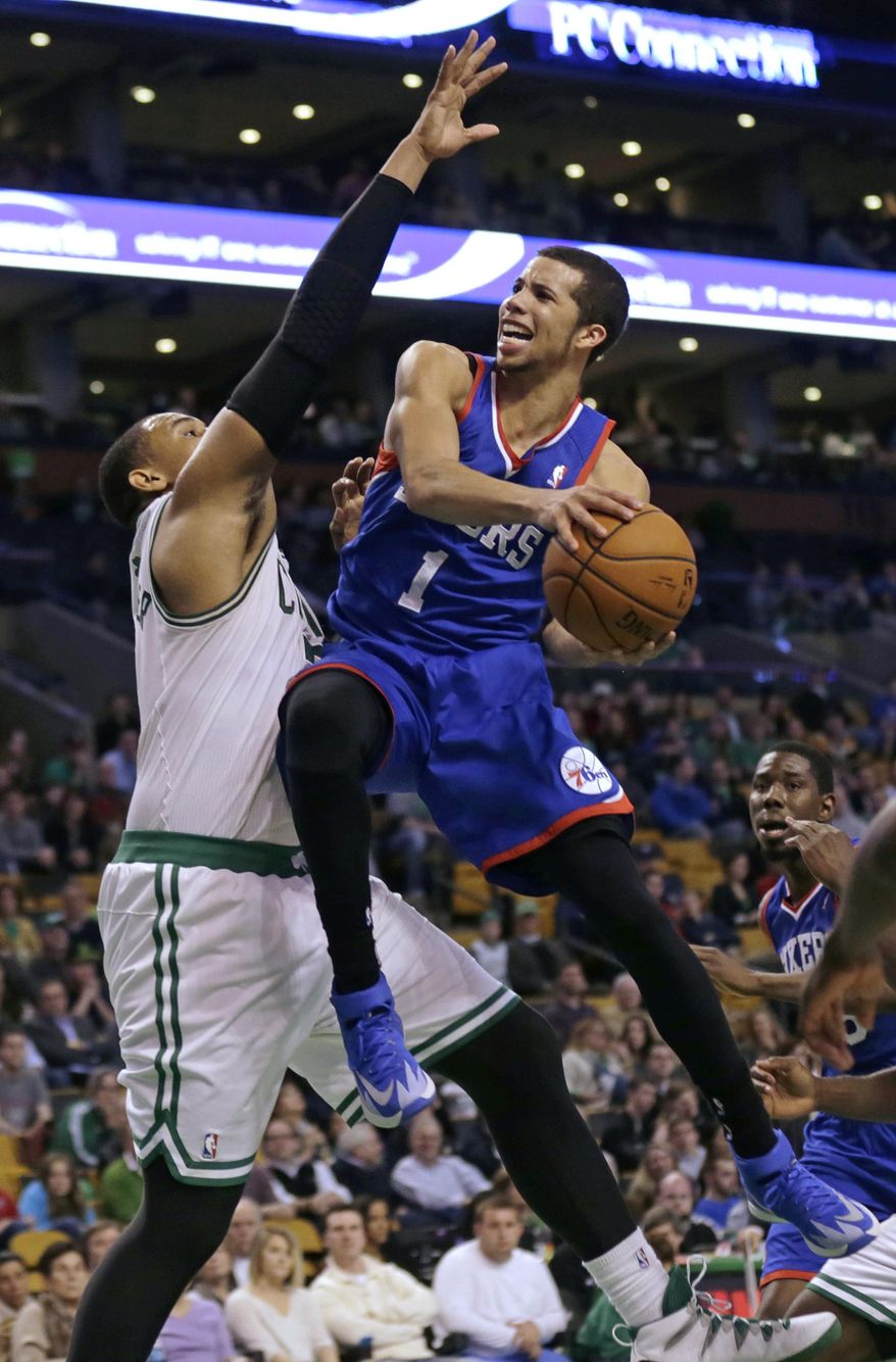 Philadelphia 76ers guard Michael Carter-Williams (1) drives to the basket against Boston Celtics center Jared Sullinger, left, during the second half of an NBA basketball game Friday, April 4, 2014, in Boston. Carter-Williams had 24 points in the 76ers 111-102 win. (AP Photo/Charles Krupa)