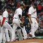 Boston Red Sox relief pitcher Edward Mujica, far right, reacts after giving up runs against the Milwaukee Brewers as his infield joins him on the mound in the ninth inning of a baseball game at Fenway Park in Boston, Friday, April 4, 2014. The Brewers won 6-2. (AP Photo/Elise Amendola)