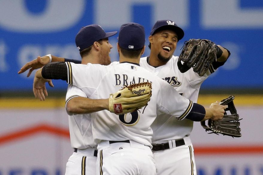 Milwaukee Brewers' Logan Schaffer, left, Ryan Braun and Carlos Gomez react after beating the Atlanta Braves in the Opening day baseball game Monday, March 31, 2014, in Milwaukee. The Brewers won 2-0. (AP Photo/Jeffrey Phelps)
