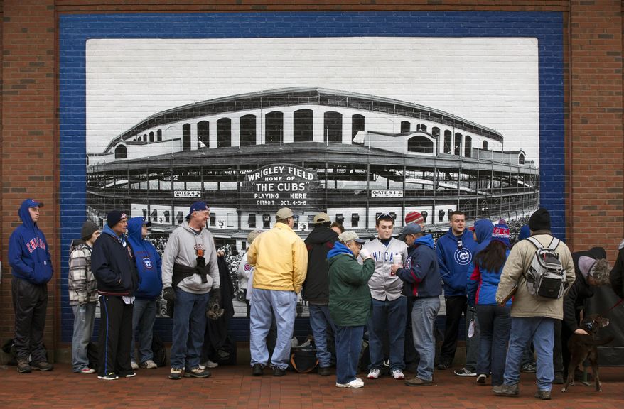 Fans line up at the gates before the Chicago Cubs home opener against the Philadelphia Phillies on Friday, April 4, 2014, in Chicago. (AP Photo/Andrew A. Nelles)