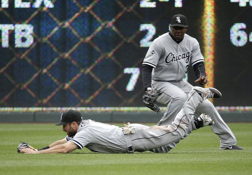 Chicago White Sox left fielder Adam Eaton fields a single by Kansas City Royals' Omar Infante during the second inning of a home opener baseball game on Friday, April 4, 2014, in Kansas City, Mo. (AP Photo/Charlie Riedel)