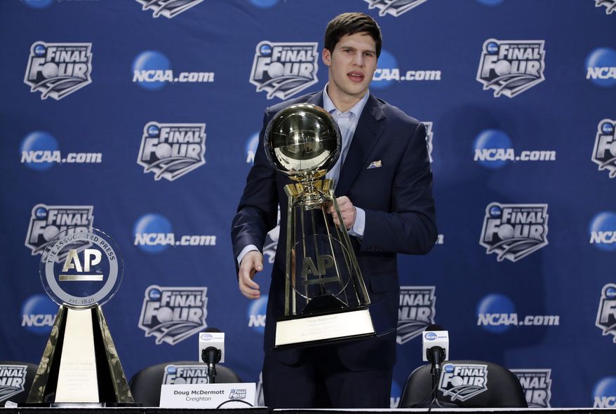 Creighton's Doug McDermott holds up his AP College Basketball Player of the Year trophy at a news conference Thursday, April 3, 2014, in Dallas. (AP Photo/David J. Phillip)