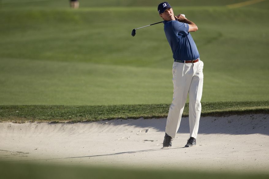 Matt Kuchar takes his second shot from a bunker on the eighteenth hole during the second round of the Houston Open golf tournament on Friday, April 4, 2014, in Humble, Texas. (AP Photo/Patric Schneider)