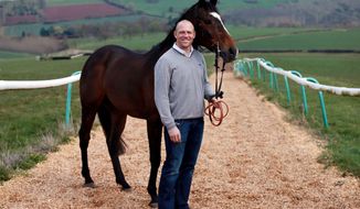 FILE - Part Owner Mike Tindall with Monbeg Dude during a stable visit at Eccleswall Court, Ross-on-Wye, England, in this undated file photo. An impulse buy after a boozy dinner with friends four years ago could pay handsome dividends for England rugby star Mike Tindall at Saturday’s Grand National Steeplechase. When Tindall raised his hand to start the bidding for a tiny 5-year-old horse called Monbeg Dude in the latter stages of a bloodstock auction at Cheltenham in May 2010, the last thing he expected was to be shelling out 12,000 pounds ($20,000) for him later that evening. (AP Photo / David Davies, file) UNITED KINGDOM OUT NO SALES NO ARCHIVE