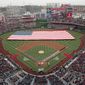 The United States Navy Ceremonial Guard stretches a large U.S. Flag across the field during the playing of the National Anthem before the baseball home opener between the Atlanta Braves and Washington Nationals at Nationals Park Friday, April 4, 2014, in Washington. (AP Photo/J. David Ake)
