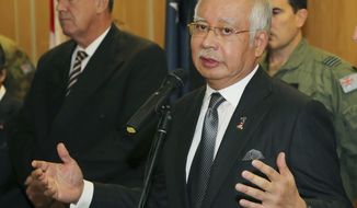 Malaysian Prime Minister Najib Razak speaks at a breakfast with crew members from different countries involved in the search for wreckage and debris of the missing Malaysia Airlines MH370 in Perth, Australia, Thursday, April 3, 2014. In a hastily called speech, Malaysian Prime Minister Najib Razak announced that an unprecedented analysis of satellite signals concluded that Malaysia Airlines Flight 370 “ended” deep in the Indian Ocean, far from any possible refuge for the 239 souls aboard. (AP Photo/Rob Griffith, Pool)