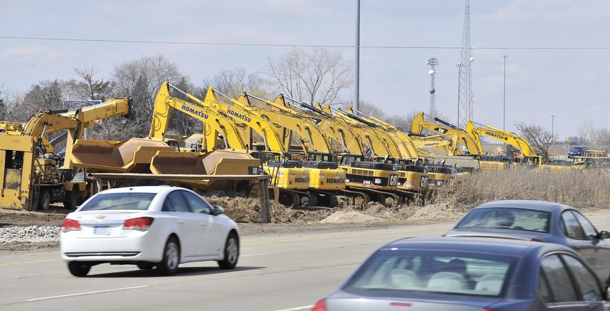 Construction equipment sits near the I-96 and I-275 interchange in Livonia, Mich. on April 1, 2014. The Michigan Department of Transportation says a several-mile stretch of Interstate 96 in Livonia and Wayne County's Redford Township is being shut down Saturday, weather permitting. The $148 million project to rebuild the roadway also includes bridge repair and replacement work. Details are posted on a website for the project. (AP Photo/Detroit News, Robin Buckson)