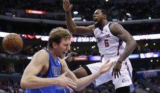 Los Angeles Clippers&#39; DeAndre Jordan, right, screams after making a dunk in front of Dallas Mavericks&#39; Dirk Nowitzki during the first half of an NBA basketball game Thursday, April 3, 2014, in Los Angeles. (AP Photo/Jae C. Hong)
