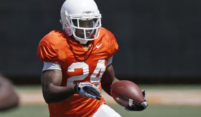 Oklahoma State wide receiver Tyreek Hill (24) carries the ball during an Orange Blitz NCAA college spring football practice in Stillwater, Okla., Saturday, April 5, 2014. (AP Photo/Sue Ogrocki)