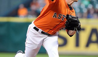 Houston Astros&#39; Lucas Harrell delivers a pitch in the first inning of a baseball game against the Los Angeles Angels, Friday, April 4, 2014, at Minute Maid Park in Houston. (AP Photo/Eric Christian Smith)