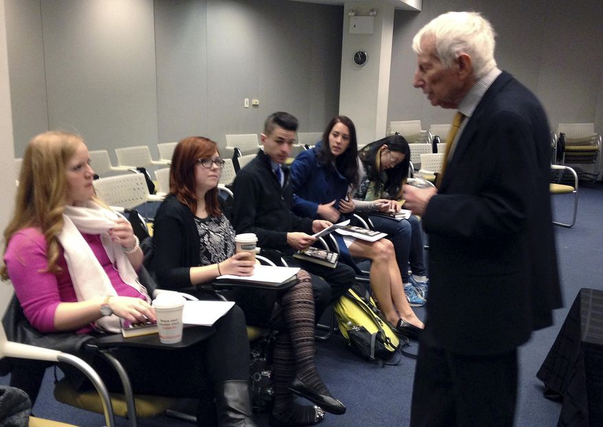 In this Jan. 27, 2014 photo provided by Jane Rohman, Ilie Wacs, right, speaks to University of New Haven students gathered at the Simon Wiesenthal Museum of Tolerance in New York. The students from the Connecticut college are working on a daunting assignment: Who was the suspected Nazi who protected Wacs and his Jewish family 75 years ago from violence, and warned them to flee Vienna, Austria just before World War II broke out? (AP Photo/Jane Rohman)