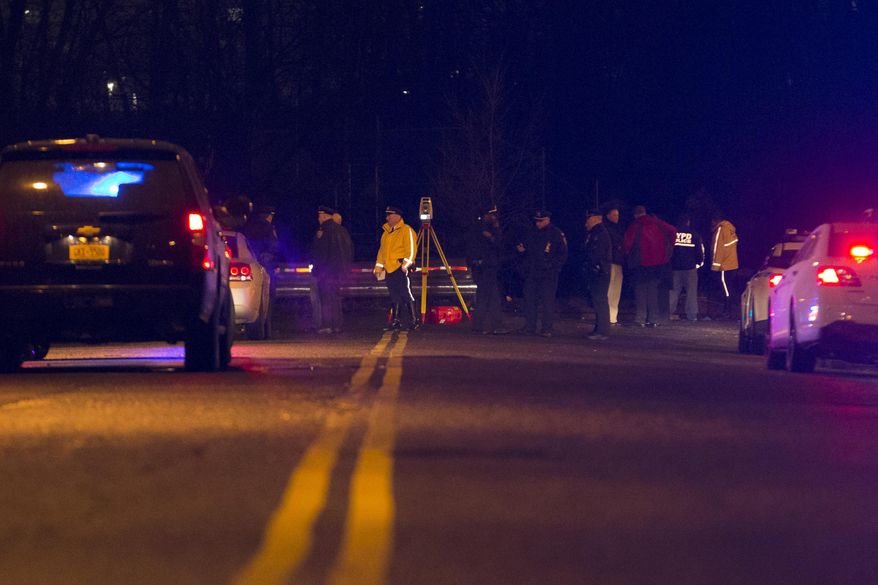 Police investigate the scene of an accident on a dead-end street where a car containing five passengers plunged into Steinway Creek in the Astoria neighborhood of Queens, Saturday, April 5, 2014, in New York. The New York Police Department says four of five people pulled from a vehicle submerged in a New York City creek have died. The fifth apparently escaped serious injury and is in stable condition. (AP Photo/John Minchillo)