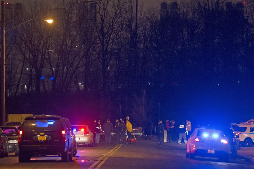 Police investigate the scene of an accident on a dead-end street where a car containing five passengers plunged into Steinway Creek in the Astoria neighborhood of Queens, Saturday, April 5, 2014, in New York. The New York Police Department says four of five people pulled from a vehicle submerged in a New York City creek have died. The fifth, believed to have been the driver, was in stable condition. (AP Photo/John Minchillo)