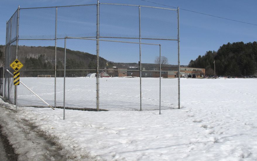 In this April 3, 2014 photo, snow covers the Montpelier High School baseball field in Montpelier, Vt. The team is scheduled to hold its first scrimmage next week followed by a game several days later. But it's likely to be the end of the month before the field can be used. (AP Photo/Wilson Ring)