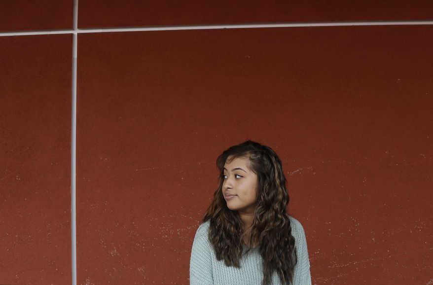 In this March 3, 2014 photo, Abraham Lincoln High School senior Jessica Hernandez is interviewed outside of her classroom in San Francisco. Hernandez, 17, had hoped to attend UC Berkeley but got a D in geometry in 10th grade, had to repeat it online after school, got behind in some classes and saw her grades slide. Hernandez now plans to attend community college and hopes to attend Berkeley as a junior and become the first in her family to earn a degree. (AP Photo/Jeff Chiu)