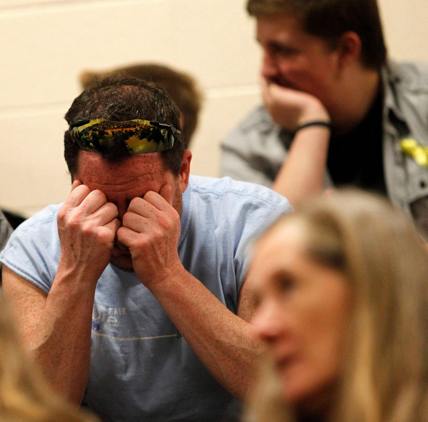 A man becomes emotional during a prayer service at Haller Middle School in Arlington on Friday, April 4, 2014. The Arlington Ministerial Association, a collective of over 30 churches, hosted the event. (AP Photo/POOL, Genna Martin)