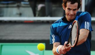 Britain&#39;s Andy Murray returns the ball to Italy&#39;s Andreas Seppi during their Davis Cup World Group quarterfinal match in Naples, Italy, Friday, April 4, 2014. (AP Photo/Salvatore Laporta)