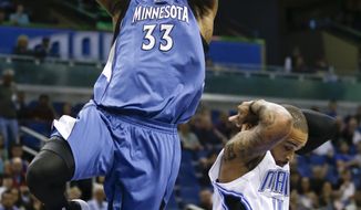 Minnesota Timberwolves&#x27; Dante Cunningham (33) gets past Orlando Magic&#x27;s Jameer Nelson for a basket during the first half of an NBA basketball game in Orlando, Fla., Saturday, April 5, 2014. (AP Photo/John Raoux)