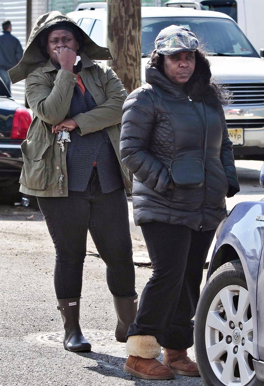 Individuals who identified themselves as family members only, watch as police recover a 2009 Honda Accord from the Steinway Creek on Saturday April 5, 2014 in New York. The driver of the car drove off a dead-end street in a desolate industrial area, flipped over a wooden curb into the East River inlet killing four passengers. The driver escaped serious injury and told officers at the scene in the Astoria section of Queens that the four were trapped in the submerged car. Fire department divers pulled the four victims from the car. Police identified them as 21-year-old Darius Fletcher, 19-year-old Jada Monique Butts, 19-year-old Crystal Gravely and 20-year-old Jaleel Furtado. They were pronounced dead at hospitals. (AP Photo/Bebeto Matthews)