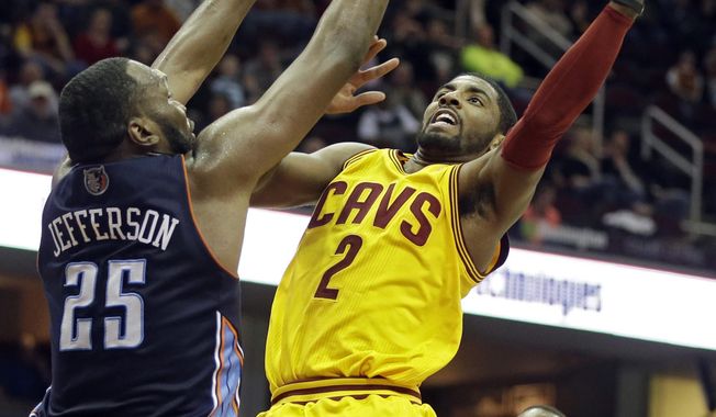 Cleveland Cavaliers&#x27; Kyrie Irving (2) shoots against Charlotte Bobcats&#x27; Al Jefferson (25) in the second quarter of an NBA basketball game on Saturday, April 5, 2014, in Cleveland. (AP Photo/Mark Duncan)