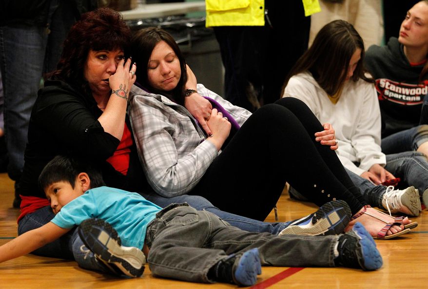 People listen to area pastors speak during a prayer service at Haller Middle School in Arlington on Friday, April 4, 2014. The Arlington Ministerial Association, a collective of over 30 churches, hosted the event. (AP Photo/POOL, Genna Martin)