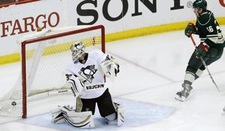 Minnesota Wild left wing Erik Haula (56), of Finland, scores against Pittsburgh Penguins goalie Jeff Zatkoff, left, during the first period of an NHL hockey game in St. Paul, Minn., Saturday, April 5, 2014. (AP Photo/Ann Heisenfelt)
