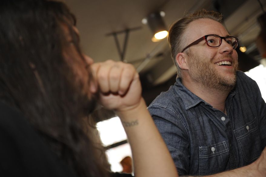 In this Friday, March 28, 2014 photo, Milam Byers, founder of The Reversal, a Nashville-based ministry that seeks to connect touring musicians for spiritual support, participates in a bible study at Edgehill Cafe in Nashville, Tenn. Four years ago, Byers, the former lead guitarist of Christian rock band Bleach, launched The Reversal. Part chaplaincy, part Bible study, part virtual community, the ministry seeks to connect touring musicians for spiritual support. (AP Photo/The Tennessean, Sanford Myers) NO SALES