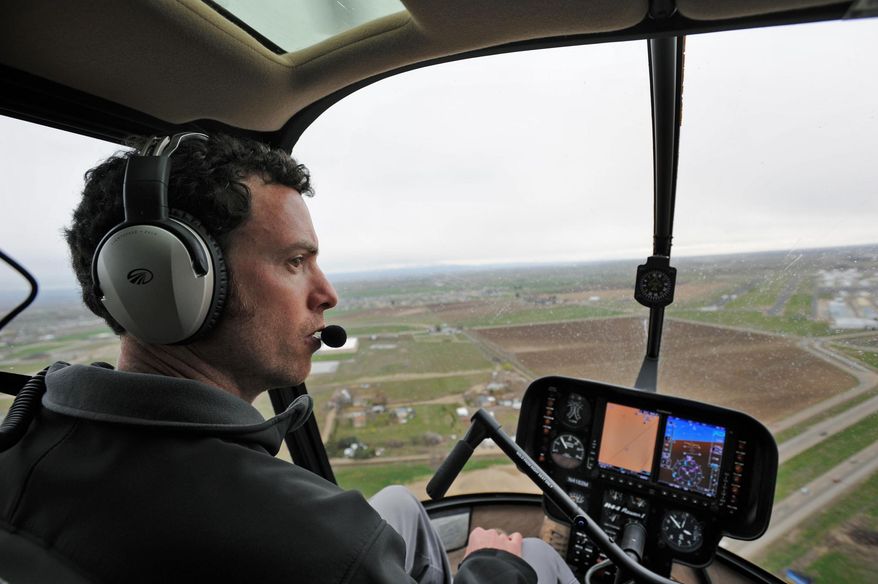 Craig Furmage, a pilot for Silverhawk Aviation, co-pilots a R44 piston engine helicopter Friday, March 28, 2014 over Caldwell, Idaho. Silverhawk Aviation is a well recognized helicopter academy located in Caldwell. (AP Photo/Idaho Press-Tribune, Adam Eschbach)