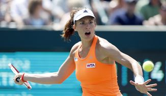 Andrea Petkovic, of Germany, returns to Eugenie Bouchard, of Canada, during the Family Circle Cup tennis tournament in Charleston, S.C., Saturday, April 5, 2014. Petkovic won 1-6, 6-3, 7-5. (AP Photo/Mic Smith)