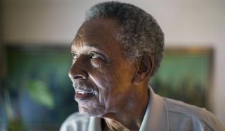 In this June 20, 2013 photo, Otis McDonald, 79, looks out the window of his home on Chicago&#39;s South Side. McDonald, who was the lead plaintiff in the lawsuit that led the U.S. Supreme Court to overturn the Chicago&#39;s handgun ban has died. McDonald&#39;s death on Friday, April 4, 2014,  was confirmed Sunday by his nephew and family spokesman, Fred Jones.   McDonald was one of four plaintiffs who challenged the city&#39;s decades-old handgun ban and who won a 5-4 decision in 2010. He argued that he was trying to protect himself and his family from the violence outside his front door in a deteriorating neighborhood on Chicago&#39;s South Side. (AP Photo/Scott Eisen)