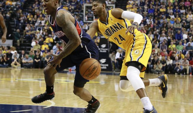Indiana Pacers forward Paul George (24) tips the basketball away from Atlanta Hawks guard Jeff Teague in the first half of an NBA basketball game in Indianapolis, Sunday, April 6, 2014. (AP Photo/R Brent Smith)