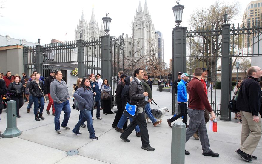 A group of Utah atheists and former Mormons march around the Salt Lake Temple Square during the Mormon church general conference Sunday, April 6, 2014, in Salt Lake City. More than 100,000 Latter-day Saints are expected in Salt Lake City this weekend for the church's biannual general conference. Leaders of The Church of Jesus Christ of Latter-day Saints give carefully crafted speeches aimed at providing members with guidance and inspiration in five sessions that span Saturday and Sunday. They also make announcements about church statistics, new temples or initiatives. In addition to those filling up the 21,000-seat conference center during the sessions, thousands more listen or watch around the world in 95 languages on television, radio, satellite and Internet broadcasts. (AP Photo/Rick Bowmer)