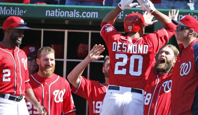 Washington Nationals&#x27; Ian Desmond (20) celebrates with Jayson Werth, second from right, and other teammates after hitting a game-winning solo home run during the seventh inning of a baseball game against the Atlanta Braves at Nationals Park, Sunday, April 6, 2014, in Washington. The Nationals won 2-1. (AP Photo/Alex Brandon)