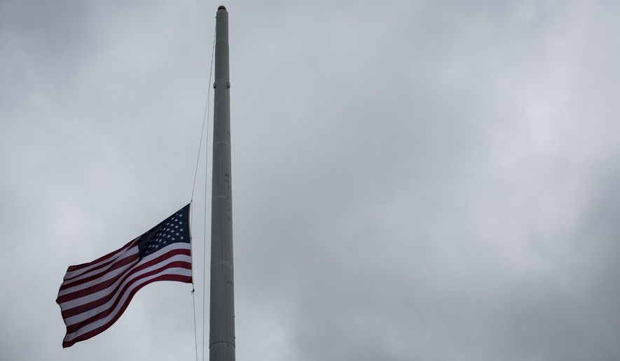An American flag flies at half-staff on Sunday, April 6, 2014, in Killeen, Texas, to honor those killed and wounded in the Fort Hood shooting on April 2. (AP Photo/ Tamir Kalifa) ** FILE **