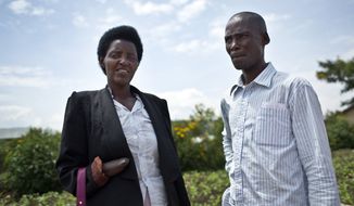In this photo taken Wednesday, March 26, 2014, Emmanuel Ndayisaba, right, and Alice Mukarurinda, pose for a photograph outside Alice&#39;s house in Nyamata, Rwanda. She lost her baby daughter and her right hand to a manic killing spree. He wielded the machete that took both. Yet today, despite coming from opposite sides of an unspeakable shared past, Alice Mukarurinda and Emmanuel Ndayisaba are friends. She is the treasurer and he the vice president of a group that builds simple brick houses for genocide survivors. They live near each other and shop at the same market. Their story of ethnic violence, extreme guilt and, to some degree, reconciliation is the story of Rwanda today, 20 years after its Hutu majority killed more than 1 million Tutsis and moderate Hutus. The Rwandan government is still accused by human rights groups of holding an iron grip on power, stifling dissent and killing political opponents. But even critics give President Paul Kagame credit for leading the country toward a peace that seemed all but impossible two decades ago. (AP Photo/Ben Curtis)