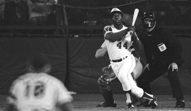 FILE - In this April 8, 1974 file photo, Atlanta Braves&#x27; Hank Aaron eyes the flight of the ball after hitting his 715th career homer in a game against the Los Angeles Dodgers in Atlanta. The 40th anniversary of Hank Aaron&#x27;s 715th home run finds the Hall of Famer, now 80, coping with his recovery from hip surgery. The anniversary of his famous homer on April 8, 1974 will be celebrated before the Braves&#x27; home opener against the Mets on Tuesday night. (AP Photo/Harry Harrris, File)